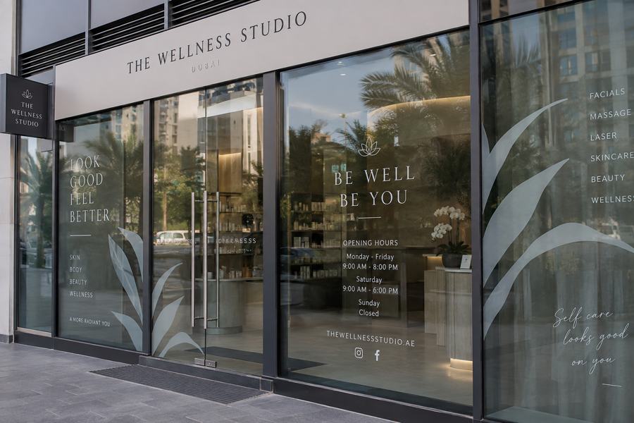 Wellness studio signage in Dubai: Frosted window vinyl, opening hours and a projecting sign